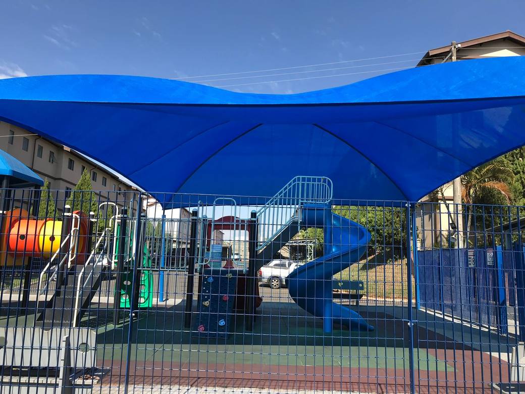 Vista de baixo da cobertura instalada, tela tensionada sobre o playground